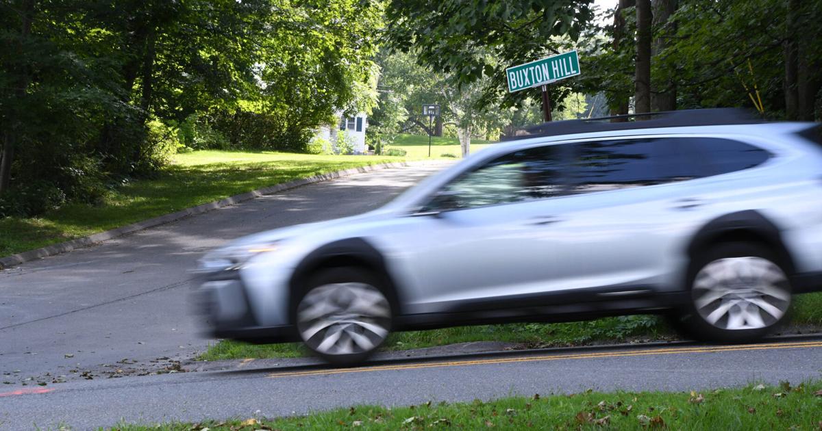 A car drives down a street