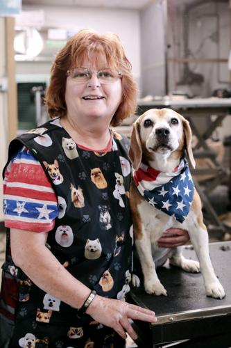 woman and beagle pose at dog grooming shop