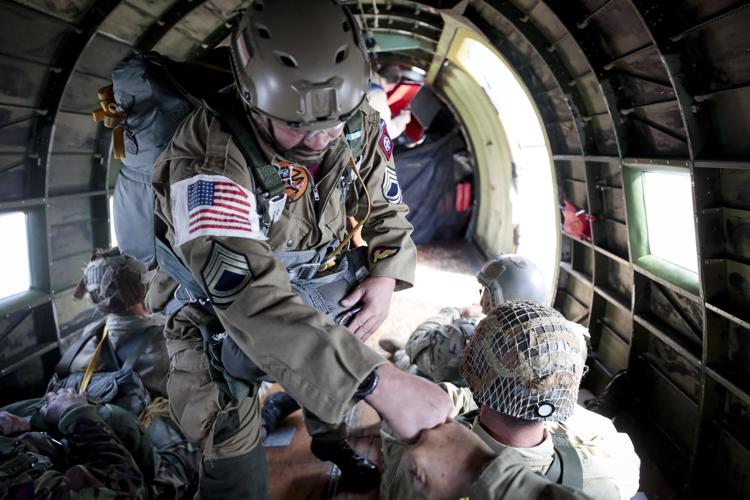 paratroopers fist bump on plane before jump