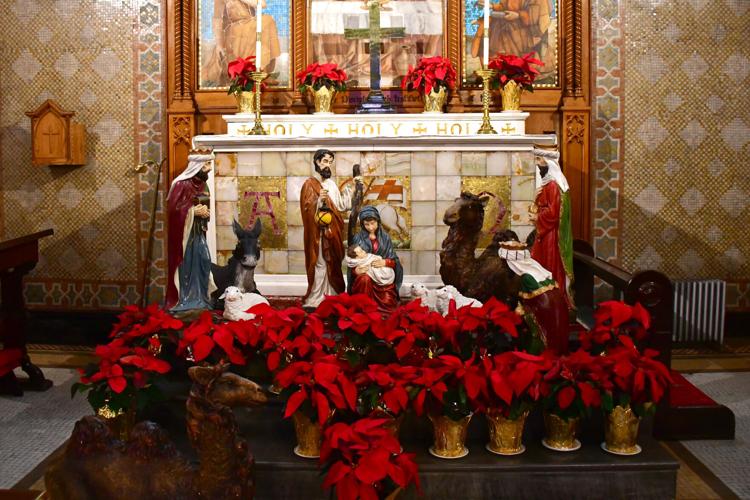 Poinsettias and a nativity on the altar