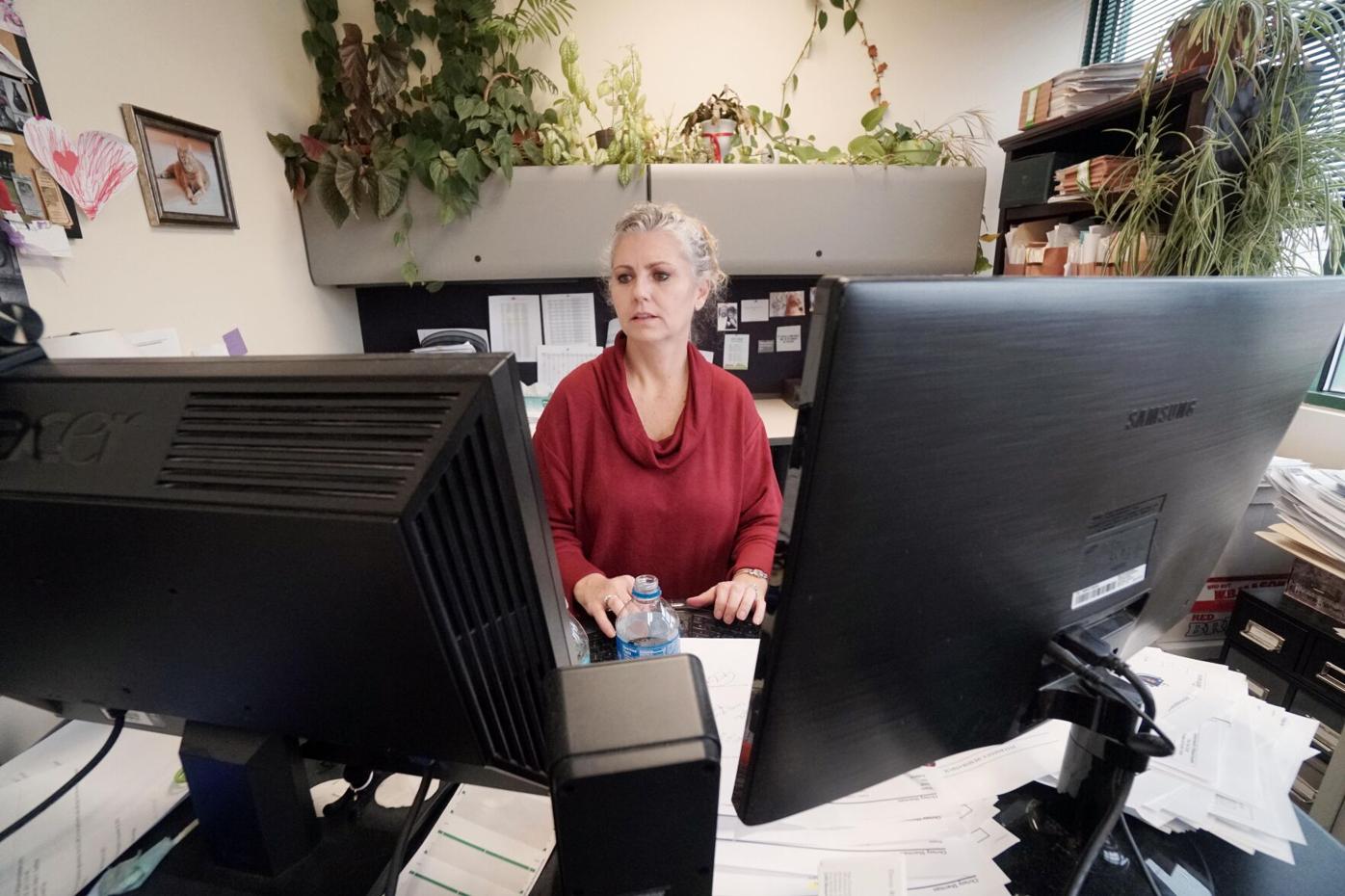 Woman looking at two computer screens