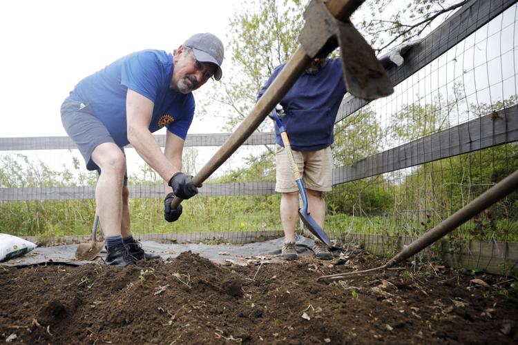 people work with garden tools in dirt