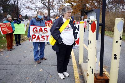 rosemary wessel speaks into security gate with protestors (copy)