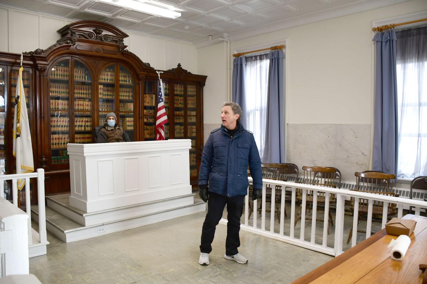 The director stands inside the courtroom