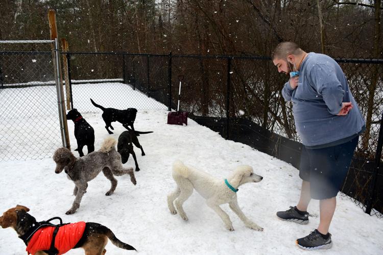Kohlenberger stands outside with some dogs
