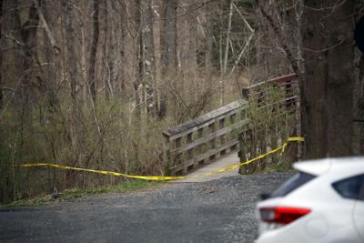 police tape across woods pond bridge