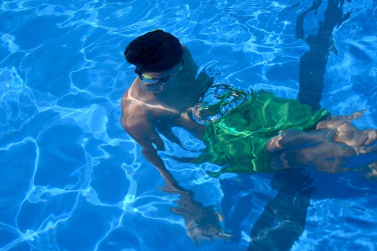 A boy swims underwater
