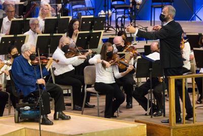 An orchestra performs on stage