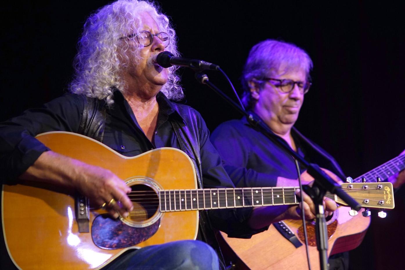 Arlo Guthrie and David Grover play guitar