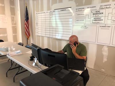Man on phone at storm command center
