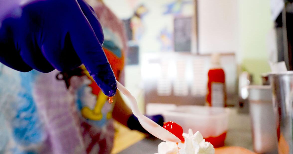 Teaghan Galeucia topping ice cream sundae with cherry