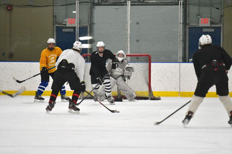 Players do a driill near the goal during practice