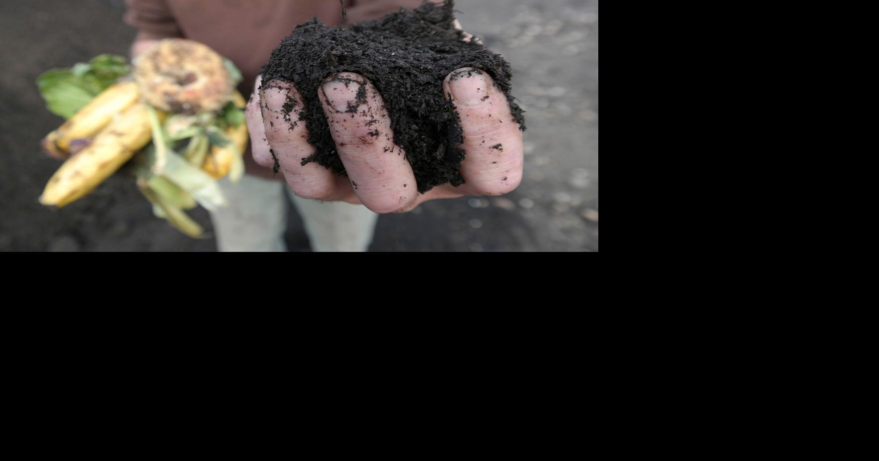 A close of of a hand holding compost