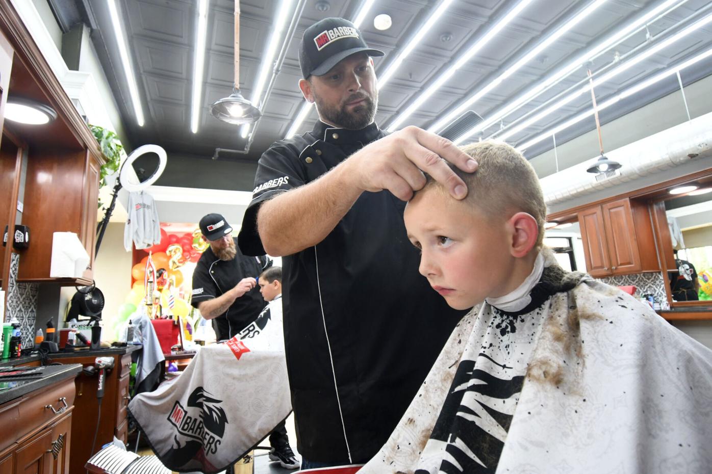 Barber cuts a boy's hair
