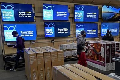 Shoppers check out TVs in store