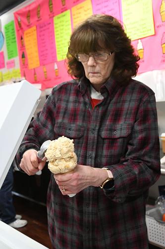 A woman scoops ice cream | | berkshireeagle.com