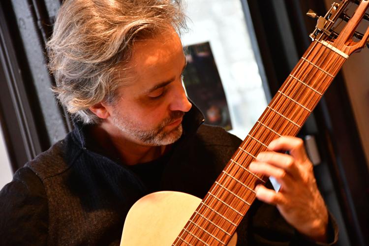 A man plays classical guitar