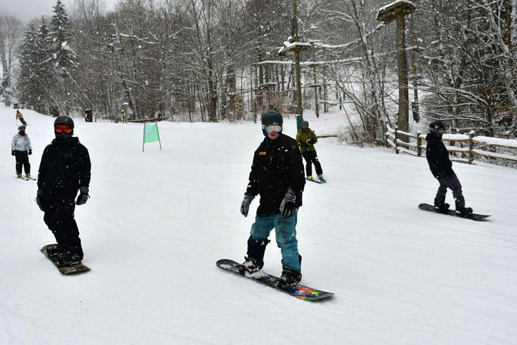 People ski and snowboard at Jiminy Peak