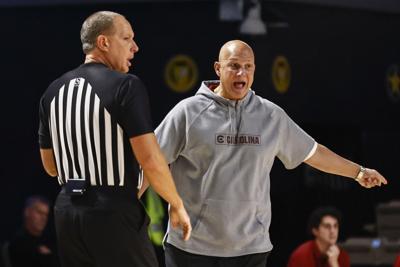 basketball coach talks to referee