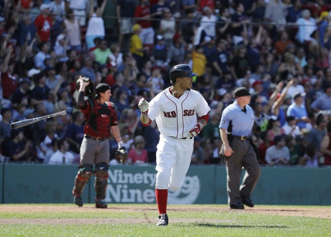 Boston Red Sox shortstop Hanley Ramirez carries his daughter
