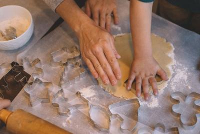 hands cutting out sugar cookies