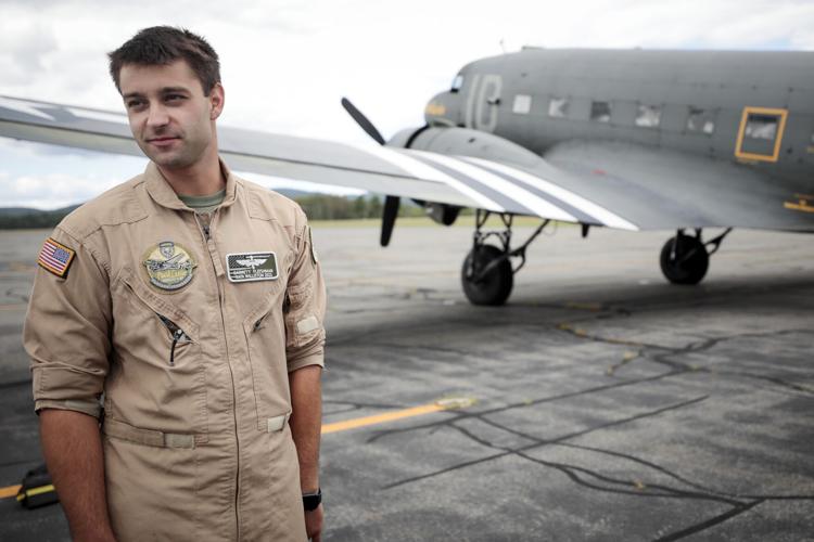 pilot garrett fleishman in front of wwii plane