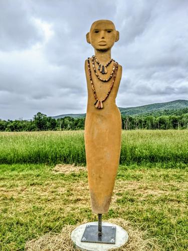 Full length view of statue in field