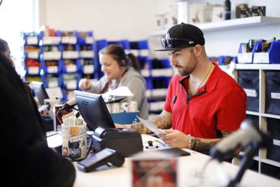 Theory Wellness cashier in red shirt