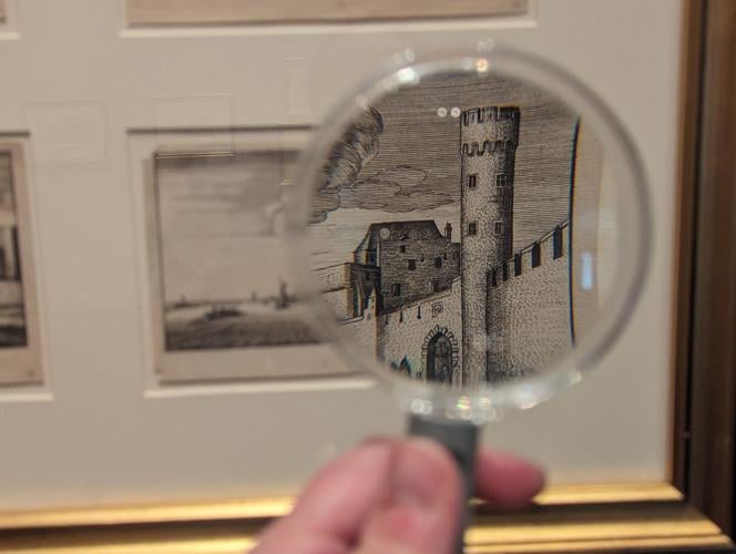 Etching of castle tower seen through magnifying glass