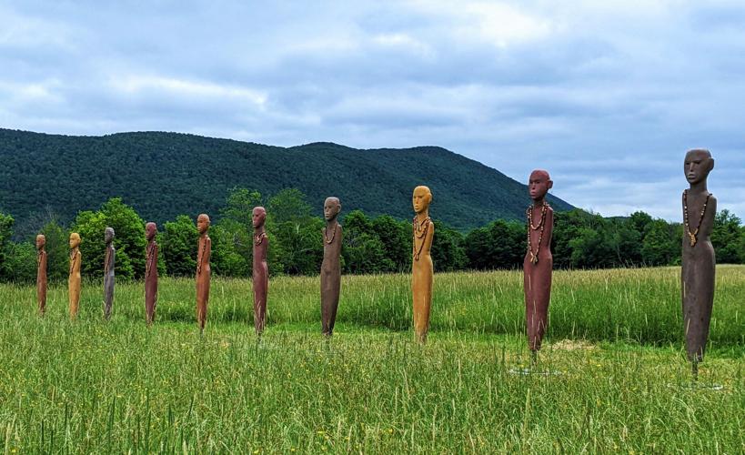 Statues in a row in a field
