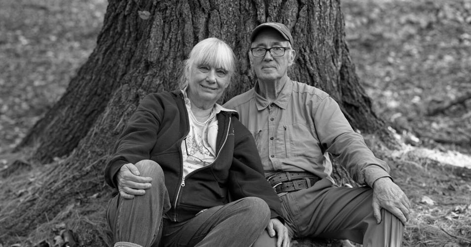 Monica and Bob Leverett sit against a tree.