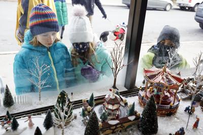 kids look at christmas window display (copy)