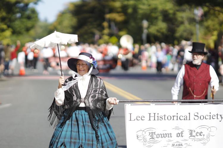 woman in colonial dress walks in parade