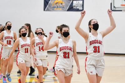 The Hoosac girls basketball team celebrate as they walk off the court