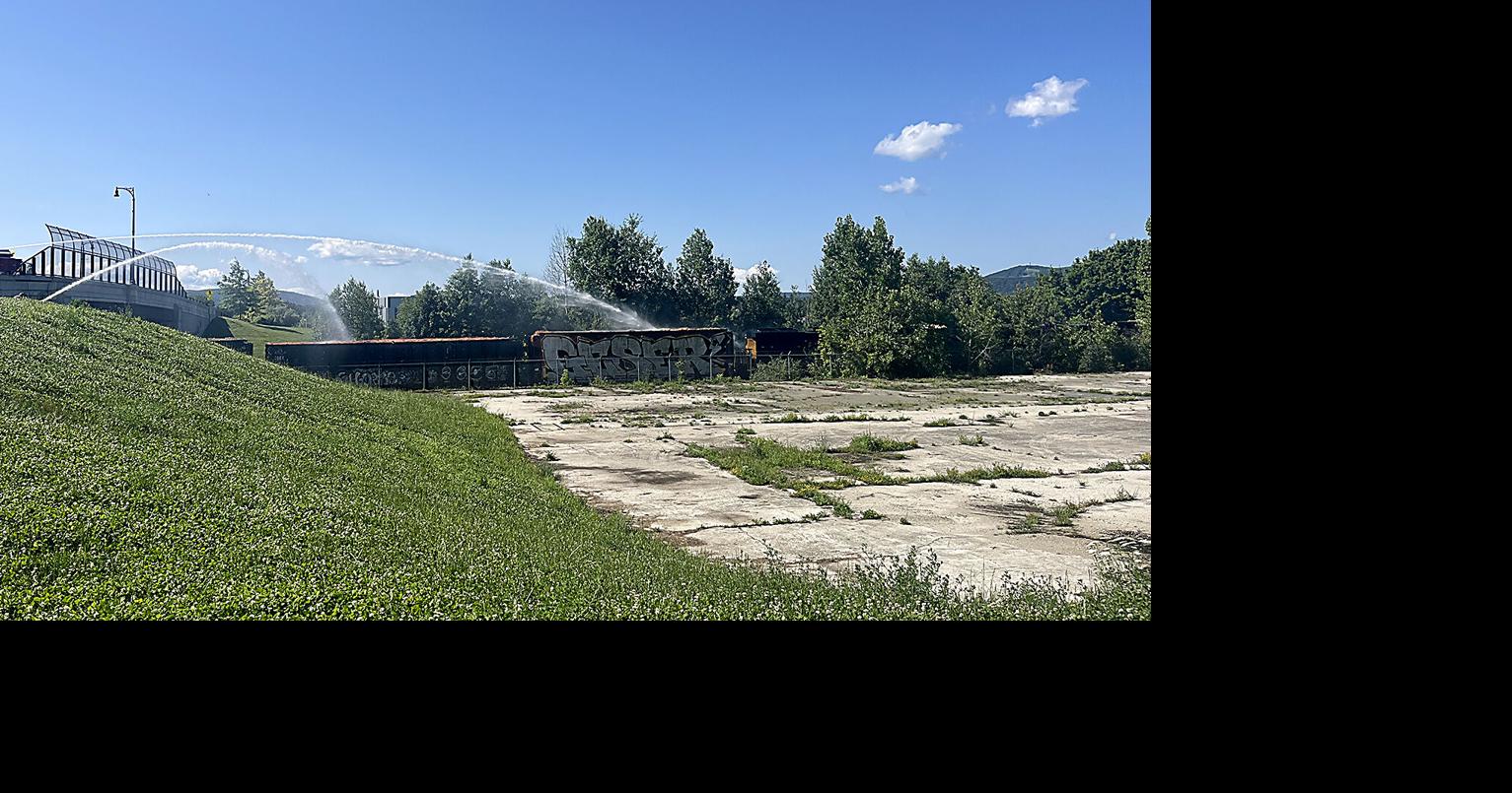 Pittsfield firefighters pour water on smoldering rail car from Woodlawn Avenue bridge