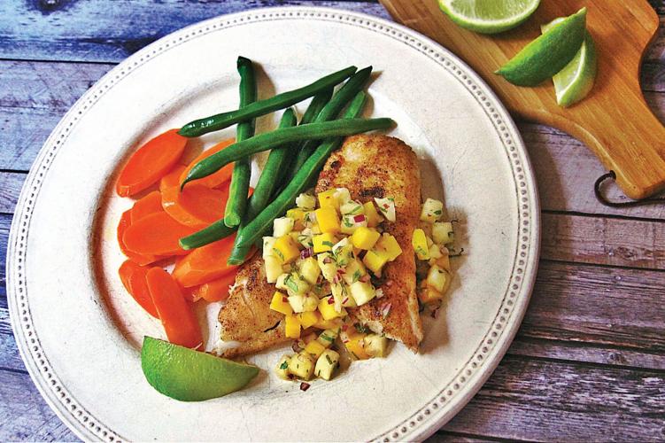 Pineapple mango salsa accents spicy sauteed fish