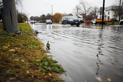 cars drive through flooded east street (copy)