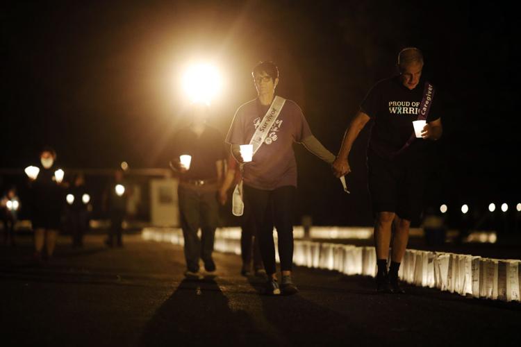 group walks at night with candles at Relay for Life (copy)