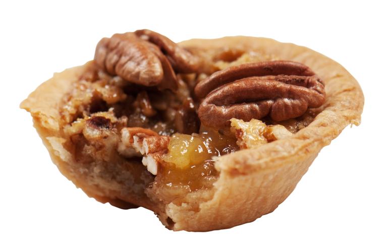 pecan tassie with white background and bite taken out of cookie