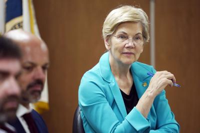 Senator Elizabeth Warren holds a pen