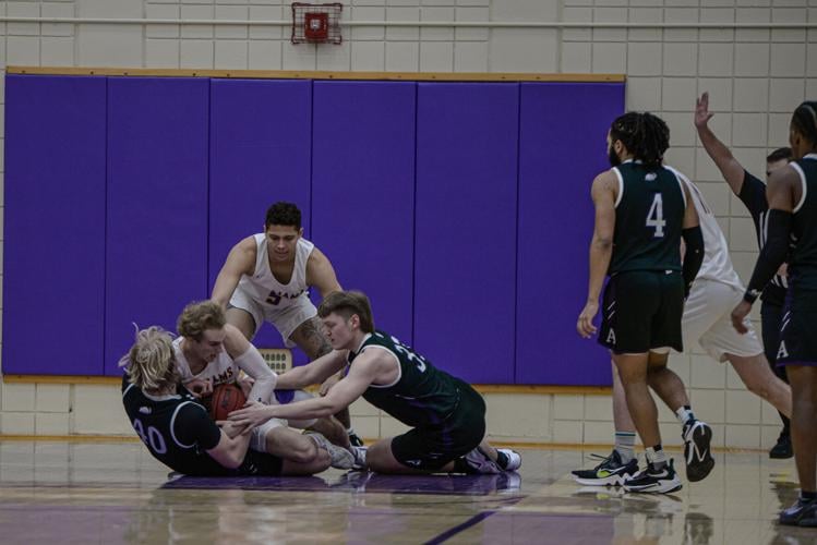 Williams' Cole Prowitt-Smith battles Amherst's Noah Helmke and Will Scherer for a loose ball