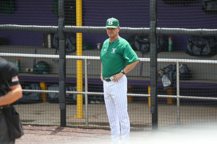 coach stands in dugout