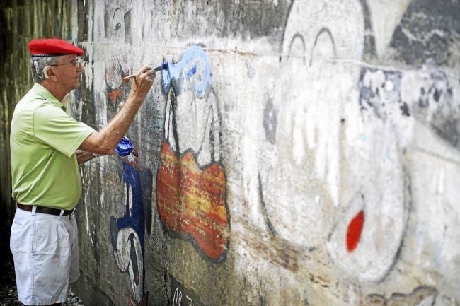 Artist, helpers freshen up cartoon walls at Hinsdale overpass