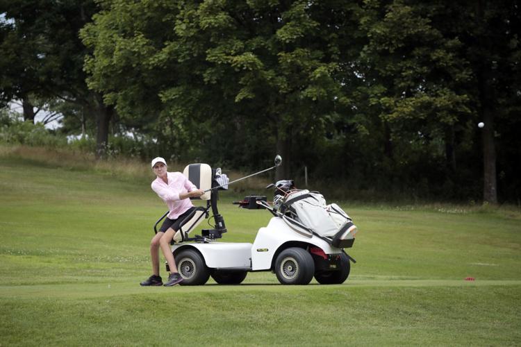 woman uses special golf cart to assist with golf swing