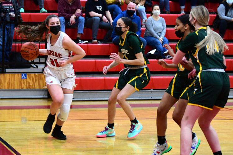 McGrath dribbles the ball as she is surrounded by Taconic defense