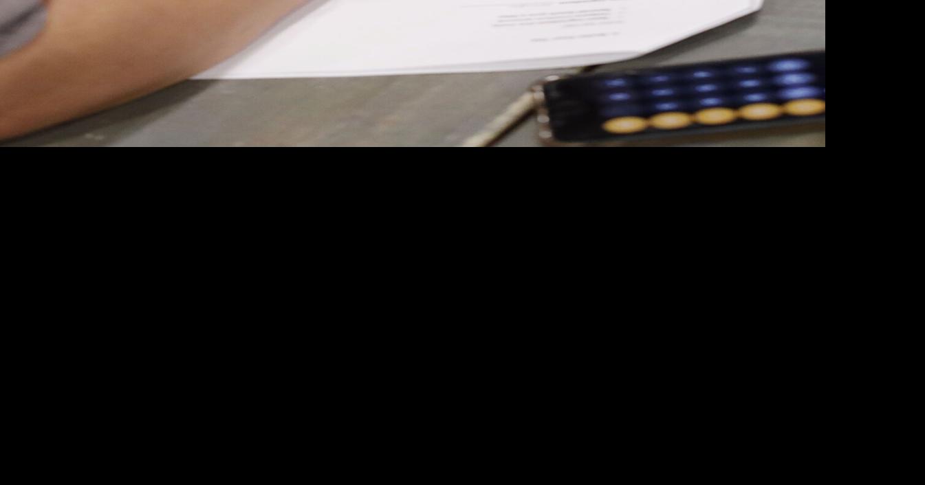 person filling out tea blending chart