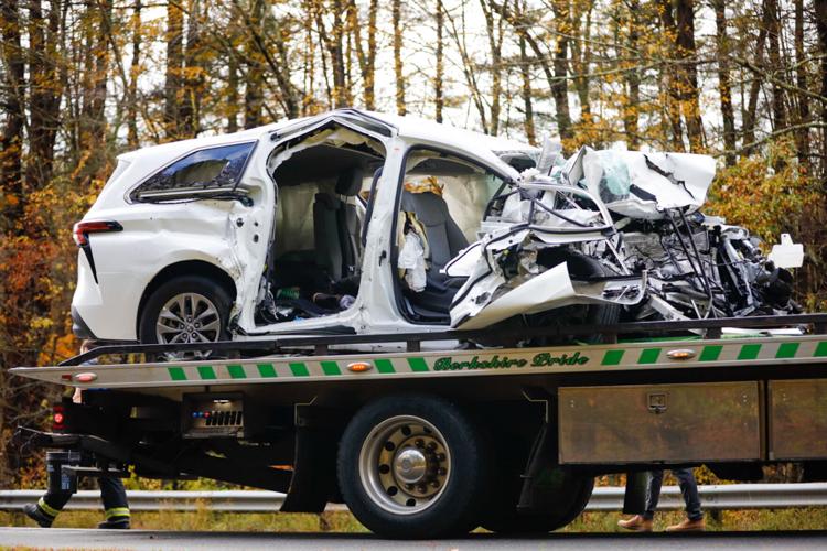The van involved in the collision shows severe damage