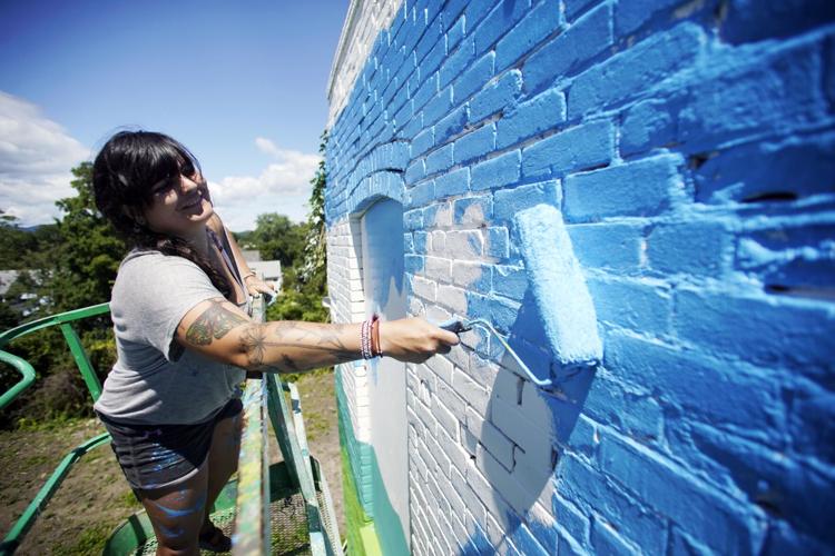 Woman paints mural
