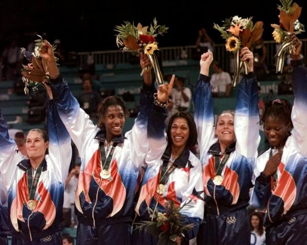 U.S. women's basketball team members wear their gold medals
