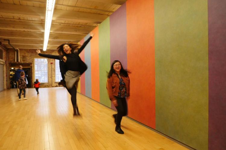 Woman jumping in air in Sol LeWitt gallery
